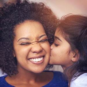 little-girl-kissing-mom-on-the-cheek-sq-300