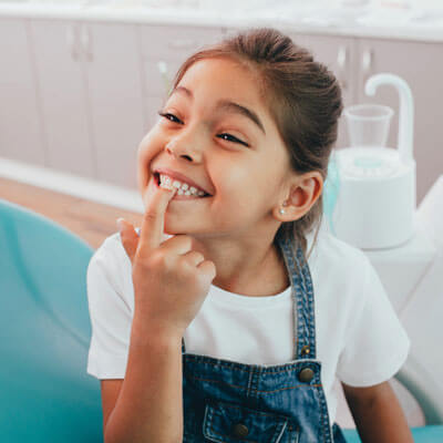 cute-girl-showing-teeth-to-dentist-sq